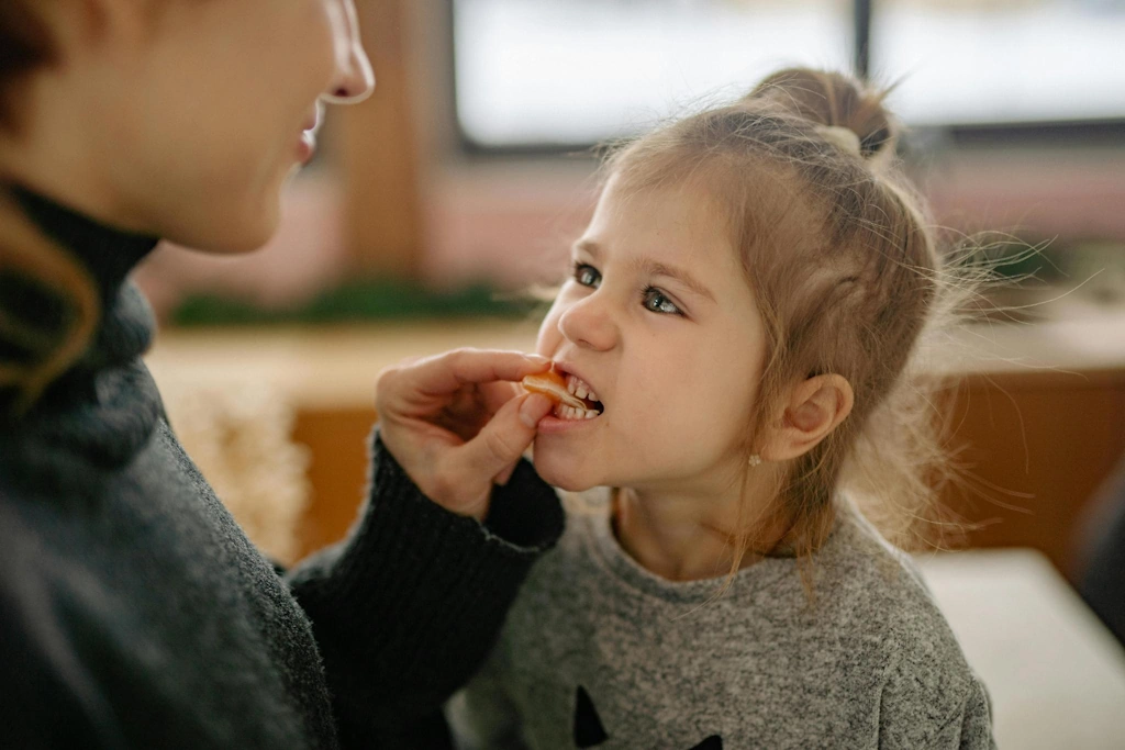 toddler reaching for hanging item